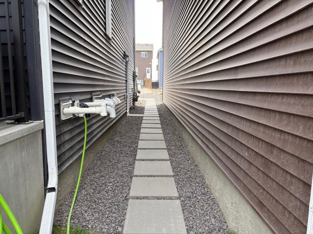 Paver path set over rock running between two homes